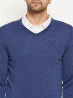 Man in 98degreenorth Men Merino Wool V-Neck Pullover-Light Denim over white shirt, shown shoulders to mid-chest.