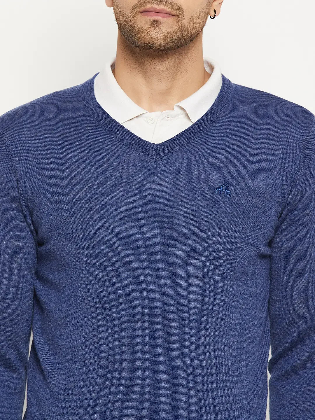 Man in 98degreenorth Men Merino Wool V-Neck Pullover-Light Denim over white shirt, shown shoulders to mid-chest.