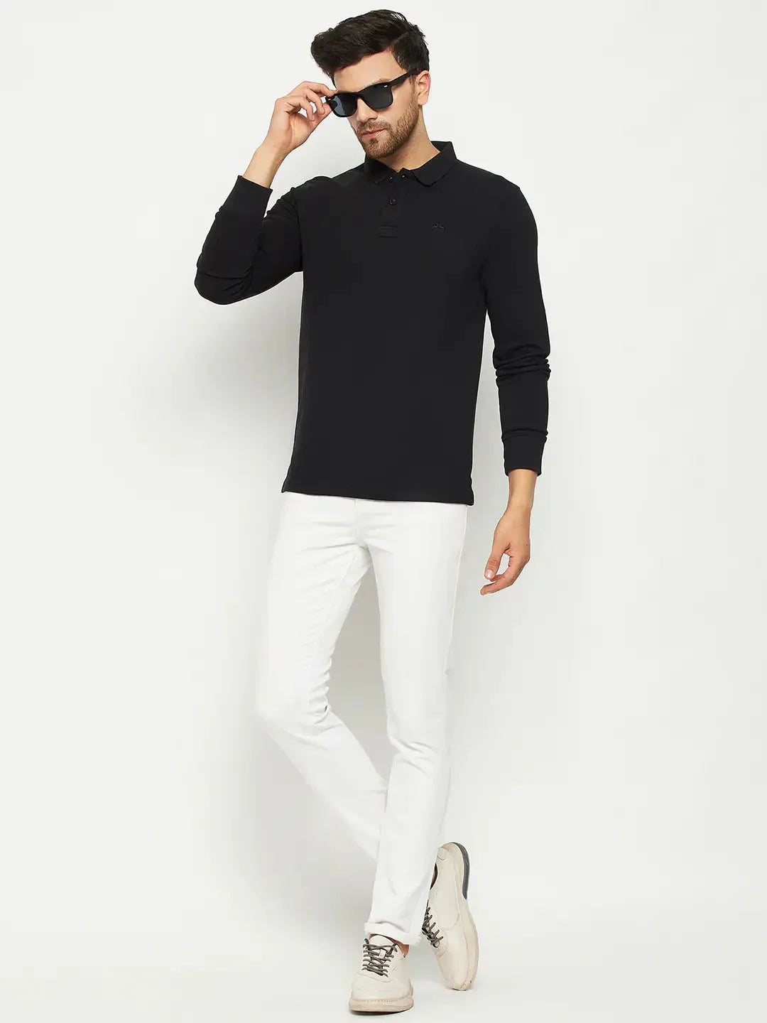 Man wearing a 98degreenorth Men Polo Collar Full Sleeves Black T-shirt, white pants, beige shoes, and sunglasses.
