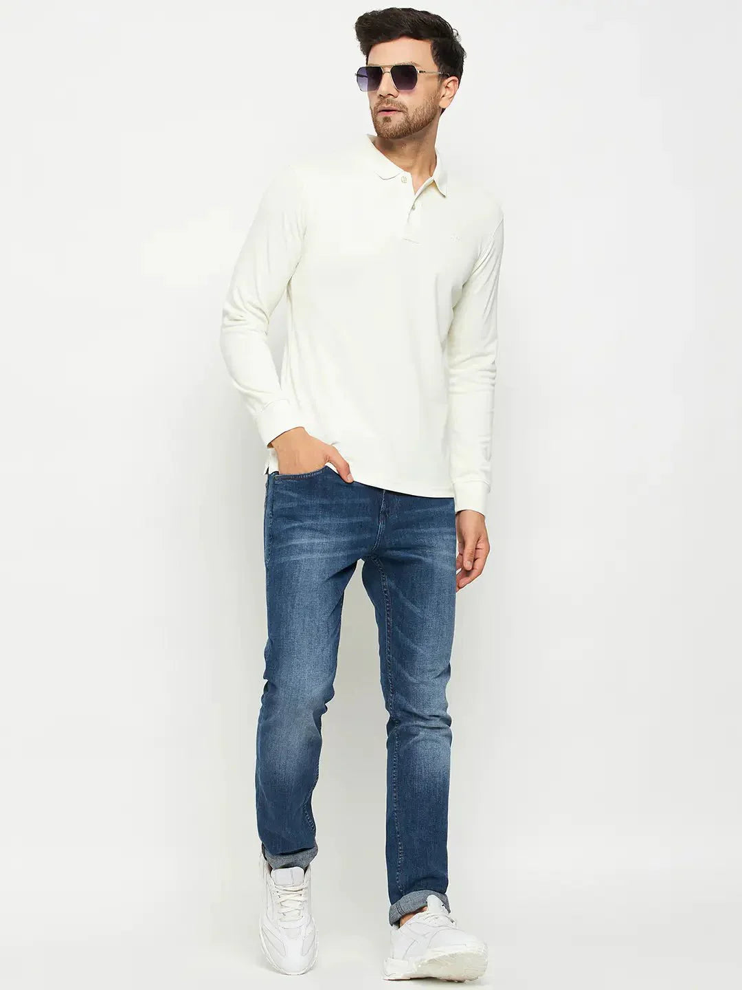 Man in sunglasses wears a 98degreenorth Men Polo Collar Full Sleeves Butter T-shirt, blue jeans, and white sneakers.