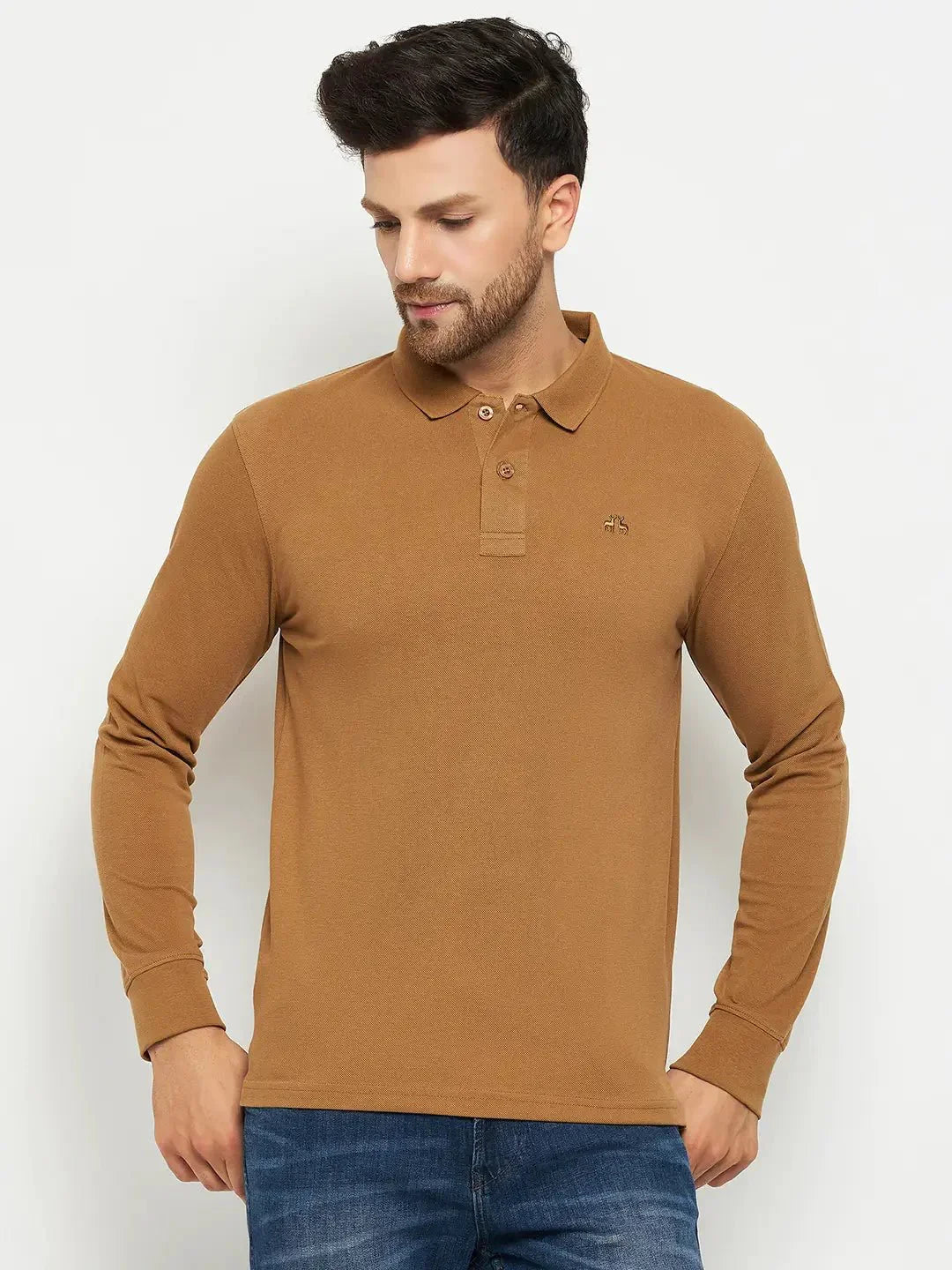 Man wearing 98degreenorth Men Polo Collar Full Sleeves Khakhi T-shirt and blue jeans against a plain light background.