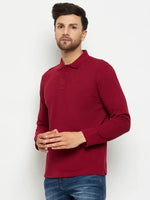 Man in a 98degreenorth Men Polo Collar Full Sleeves Maroon T-shirt and blue jeans, against a white background.