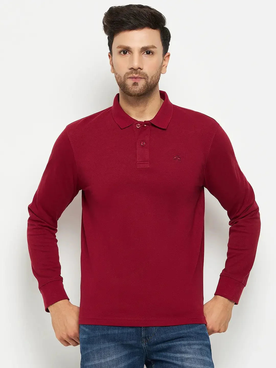 Man wearing 98degreenorth Men Polo Collar Full Sleeves Maroon T-shirt and blue jeans, on a plain white background.