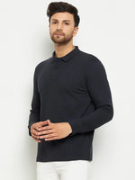 A man in a 98degreenorth Men Polo Collar Full Sleeves Navy T-shirt and white pants stands against a plain background.