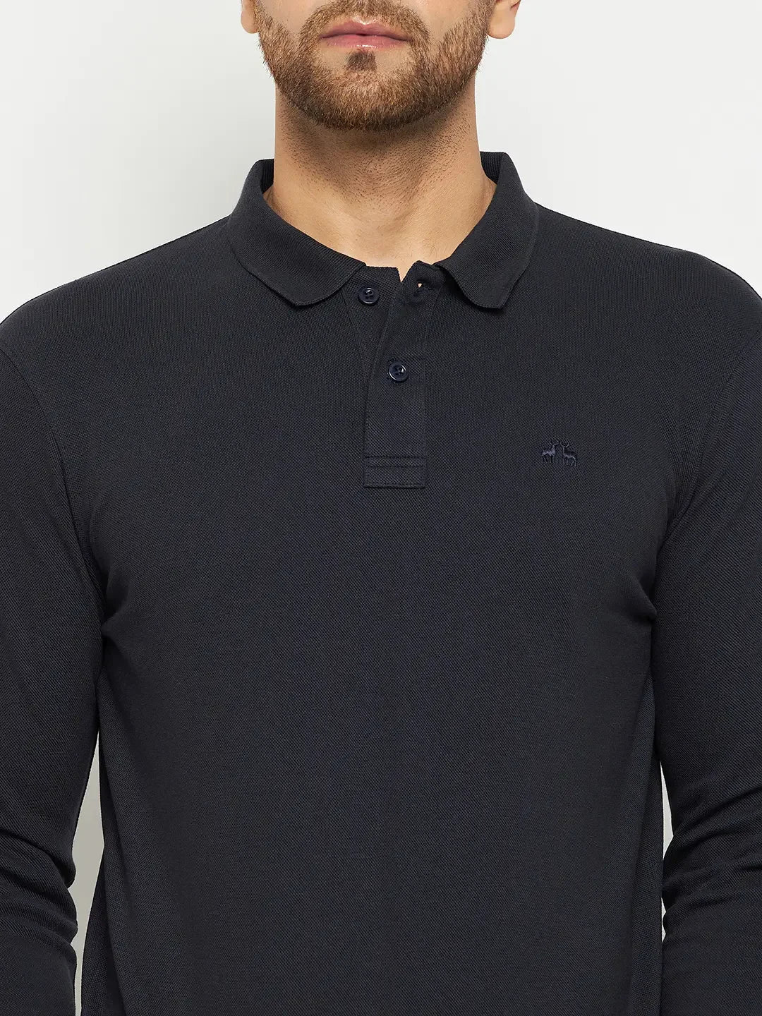 Man wears a 98degreenorth Men Polo Collar Full Sleeves Navy T-shirt, perfect for any travel wardrobe, against a plain background.