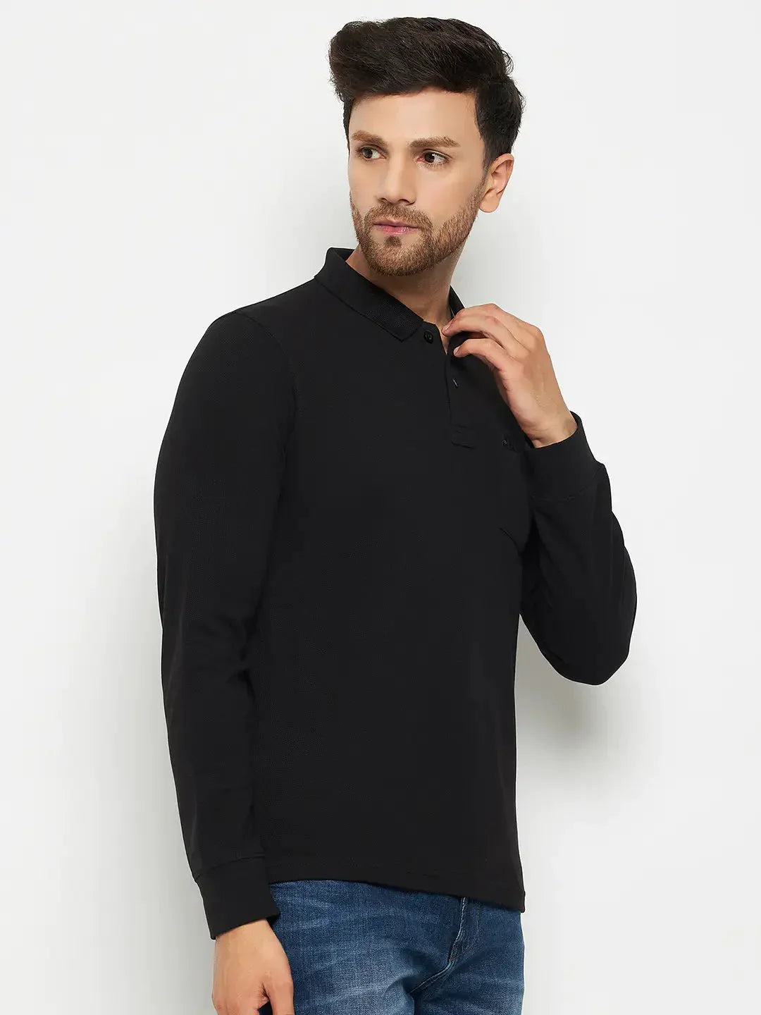 Man in 98degreenorth Men Polo Collar Full Sleeves With Pocket Black T-shirt and blue jeans, against white backdrop.