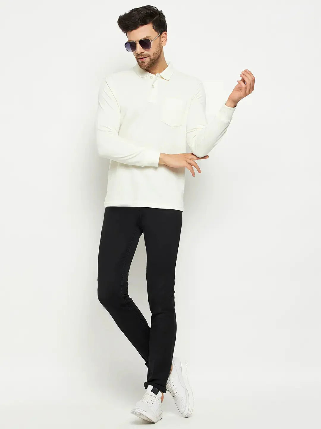 Man in sunglasses wears a 98degreenorth Men Polo Collar Full Sleeves With Pocket Butter T-shirt, black pants, and white sneakers.