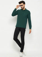 Man in sunglasses wearing a 98degreenorth Men Polo Collar Full Sleeves With Pocket Dark Green T-shirt, black pants, and white sneakers.