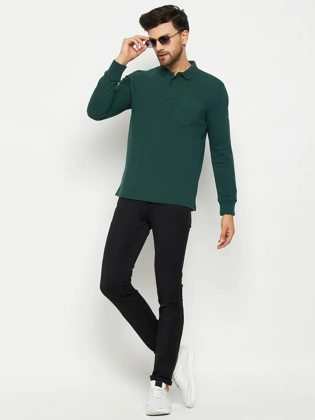 Man in sunglasses wearing a 98degreenorth Men Polo Collar Full Sleeves With Pocket Dark Green T-shirt, black pants, and white sneakers.