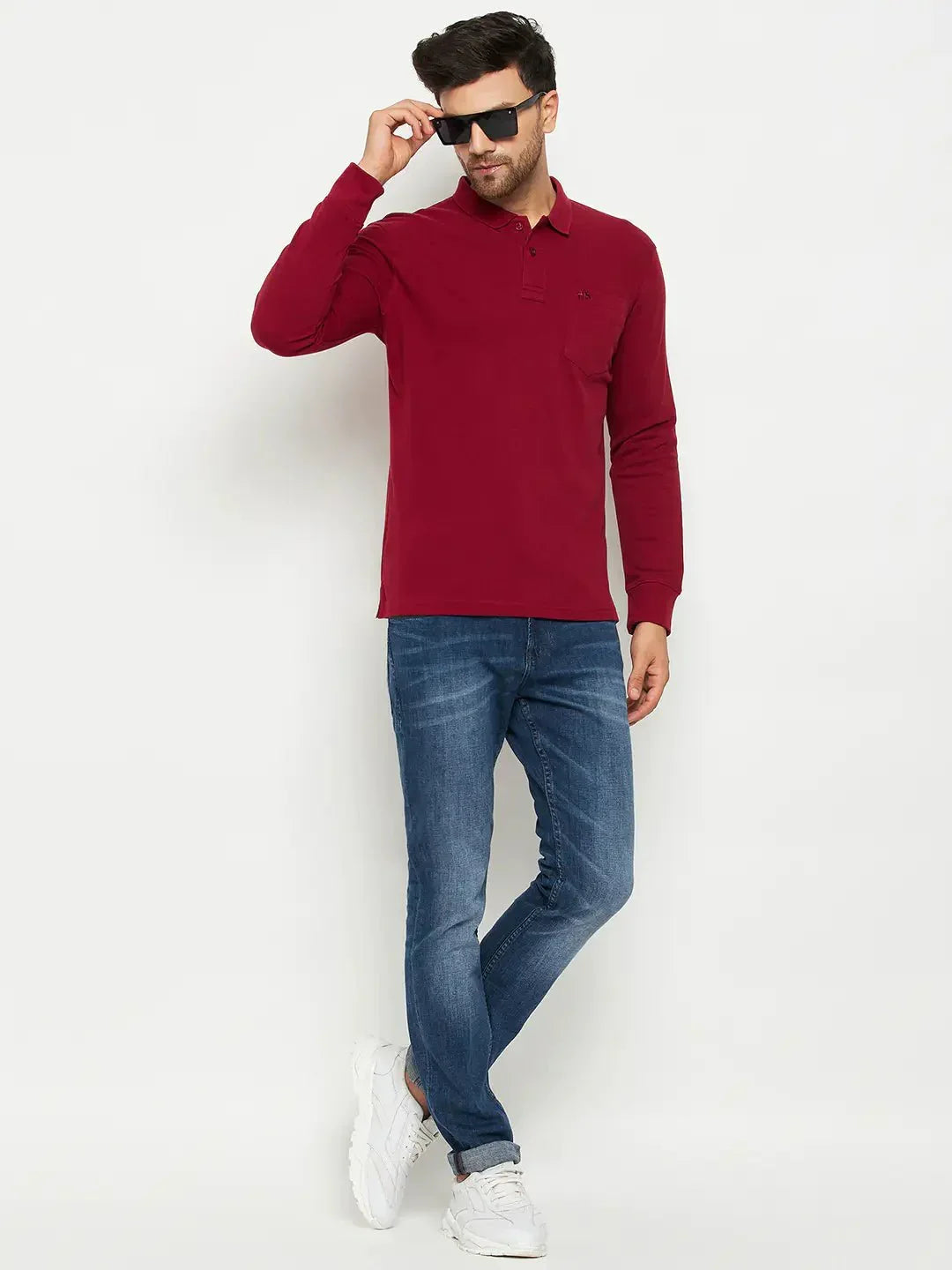 Man wearing a 98degreenorth Men Polo Collar Full Sleeves With Pocket Maroon T-shirt and jeans, great for stylish travel.