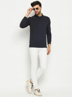 Man wears 98degreenorth Men Polo Collar Full Sleeves With Pocket Navy T-shirt and white pants against a white background.