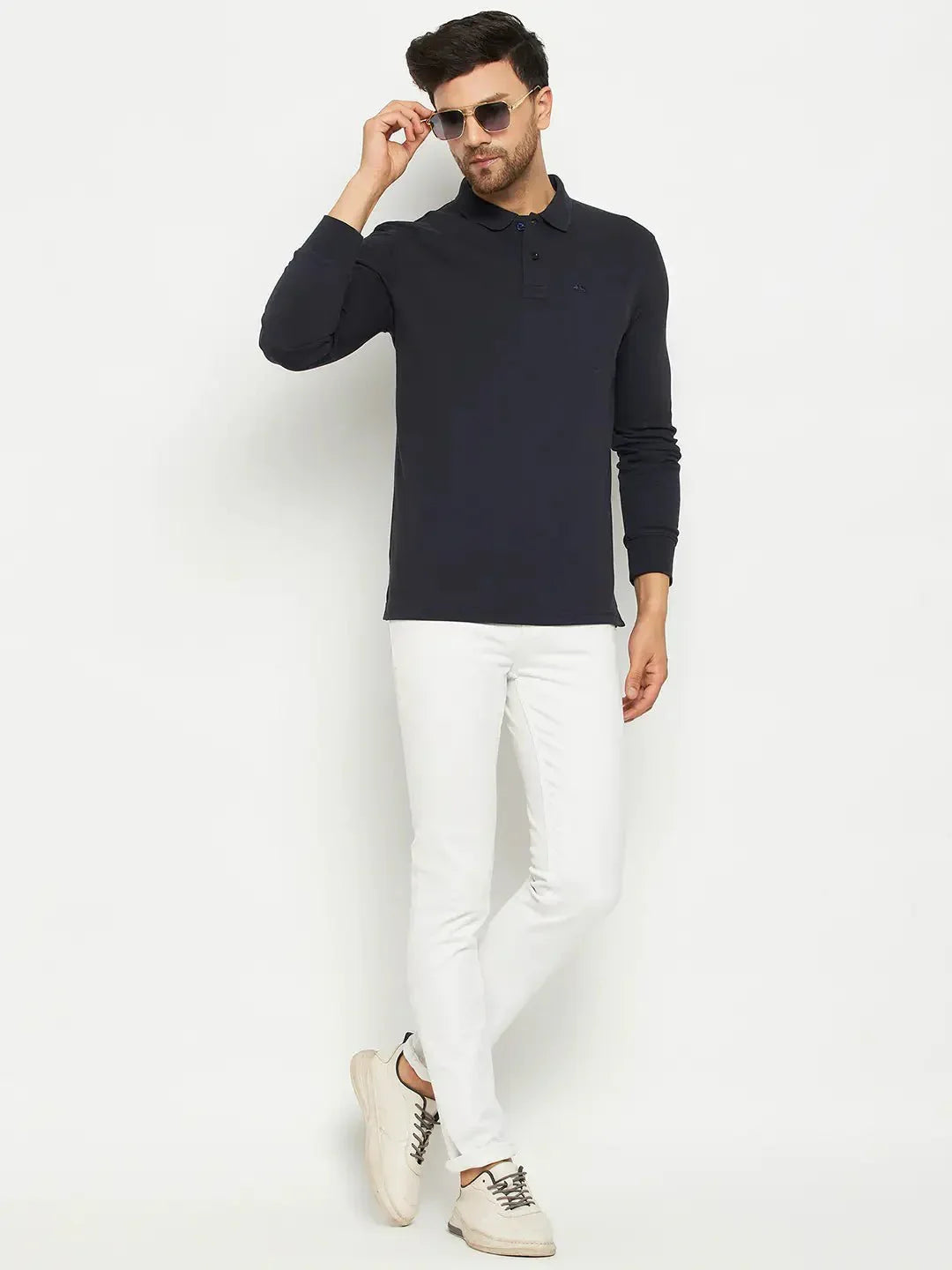 Man wears 98degreenorth Men Polo Collar Full Sleeves With Pocket Navy T-shirt and white pants against a white background.