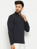 Man wearing a 98degreenorth Men Polo Collar Full Sleeves With Pocket Navy T-shirt and white pants, looking to the side.