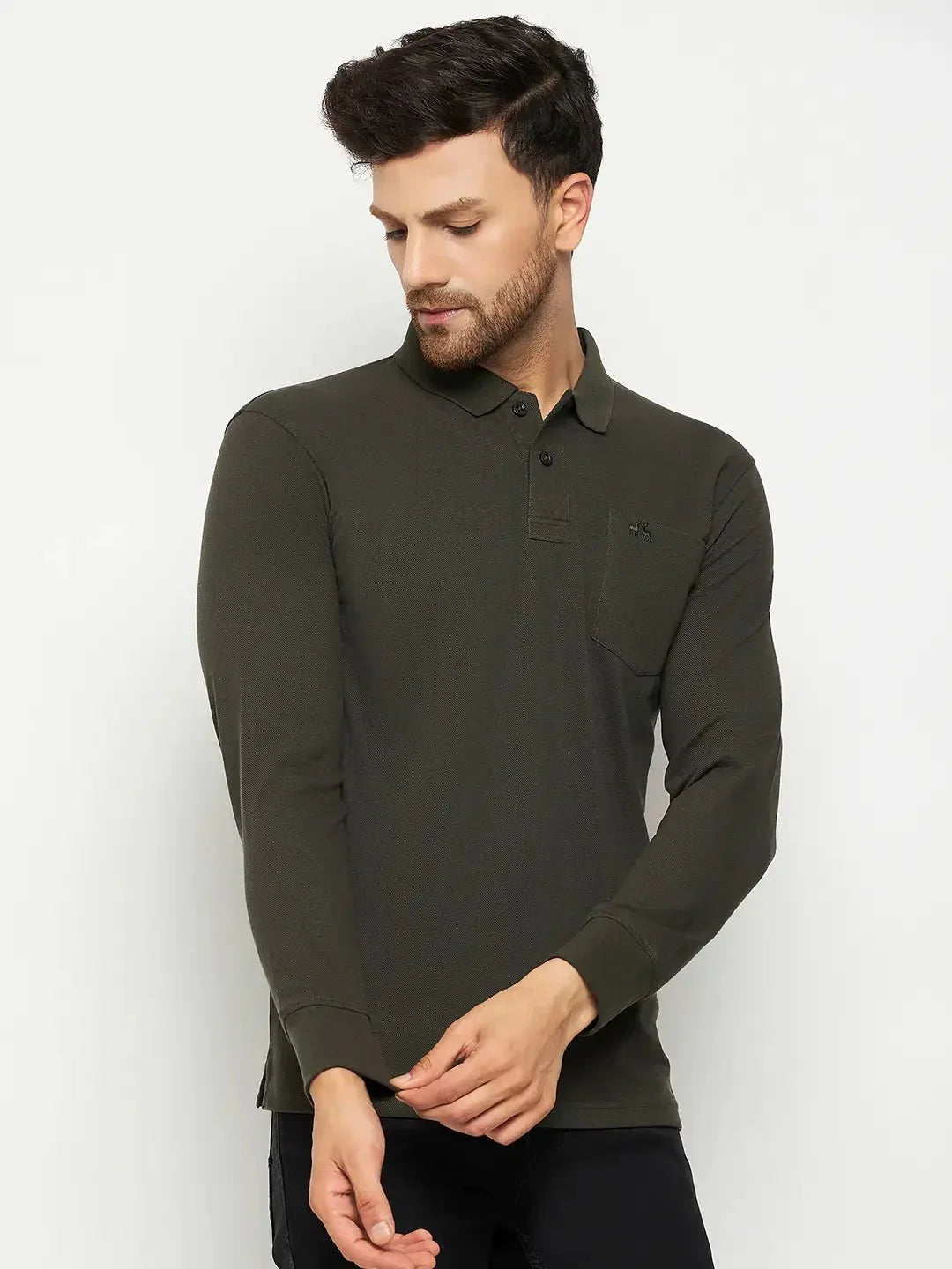 Man in 98degreenorth Men Polo Collar Full Sleeves With Pocket T-shirt - Olive, looking down and adjusting his cuff.