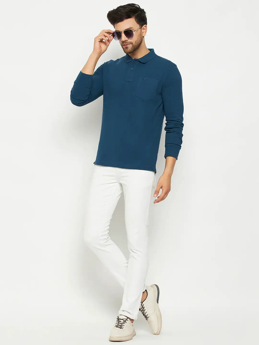 Man in 98degreenorth Men Polo Collar Full Sleeves With Pocket Teal T-shirt, white pants, and beige shoes on white background.