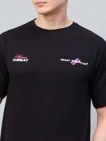 A person wears a 98degreenorth Men Typography Black Printed Round Neck T-shirt with Minor THREAT and WHAT THE FLUX logos.