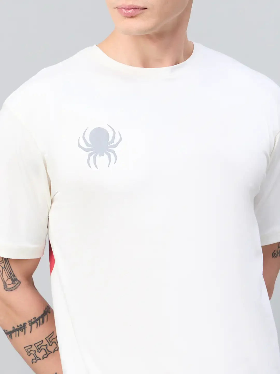 A person in a 98degreenorth Men Typography Offwhite Printed Round Neck T-shirt, streetwear style, arm tattoos visible.