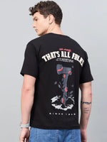 Young man in a 98degreenorth Men Typography Printed Black Round Neck T-shirt—ideal for streetwear enthusiasts.