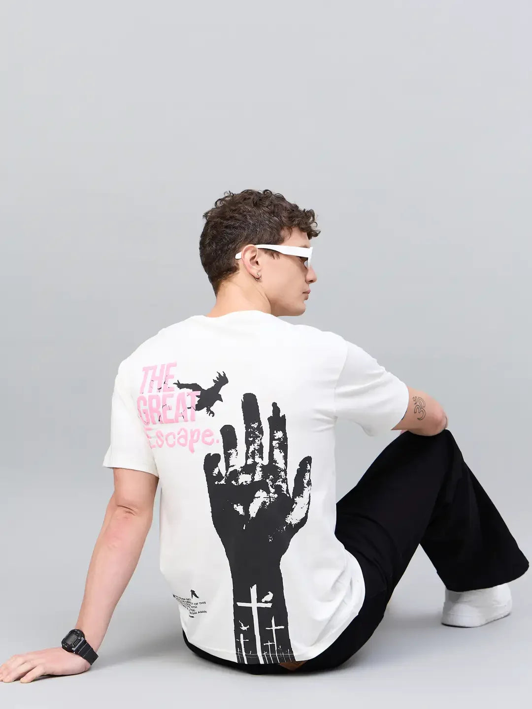 Person in sunglasses wears a 98degreenorth Men Typography Printed Offwhite Round Neck T-shirt with graphic back print.