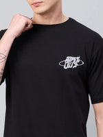 Person wearing a 98degreenorth Men Typography Printed Round Neck Black T-shirt, holding the collar.