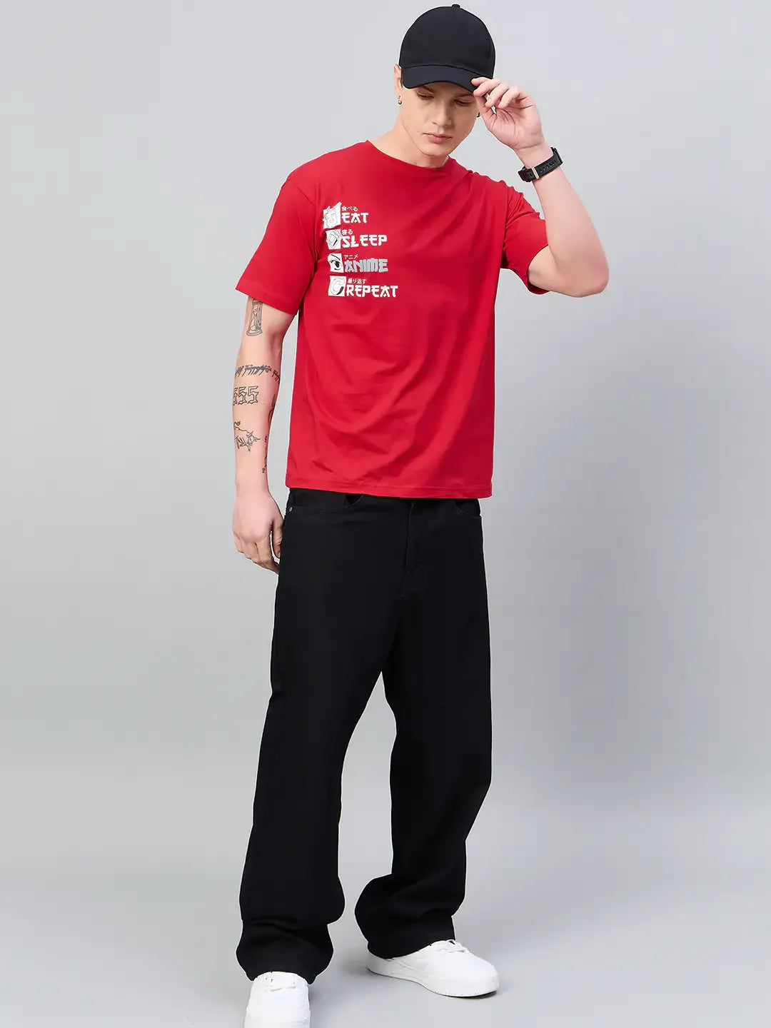 Man in an oversized 98degreenorth Men Typography Printed Round Neck Red T-shirt adjusts his black cap.
