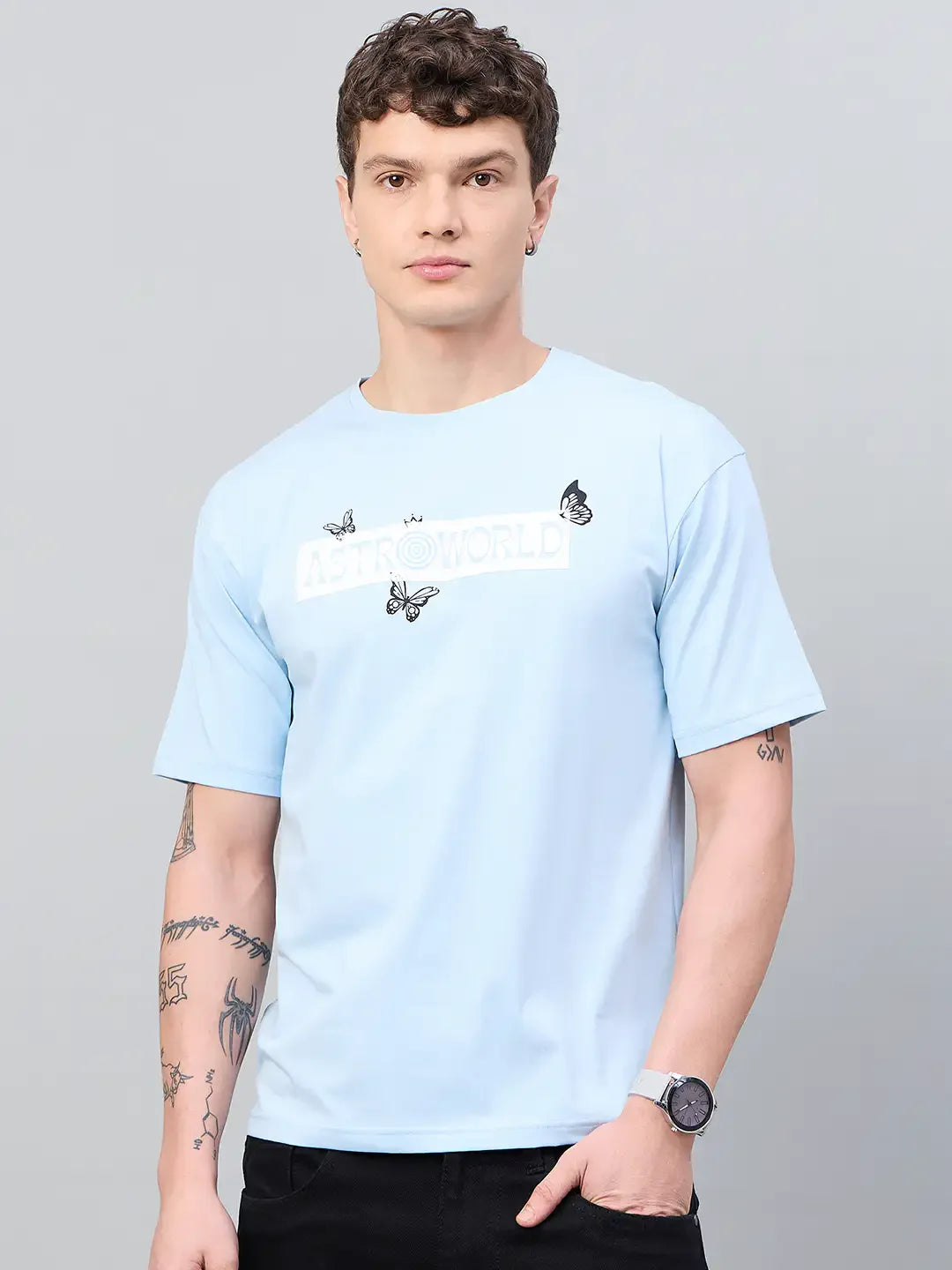 A man in a 98degreenorth Men Typography Printed Round Neck Sky-T-shirt stands against a plain gray background.