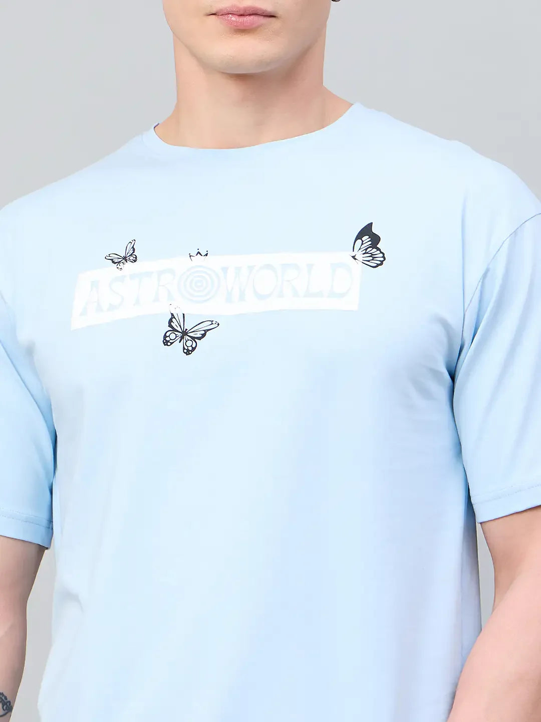 A person wears a 98degreenorth Men Typography Printed Round Neck Sky-T-shirt.