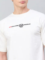 Man wears 98degreenorth Men Typography Printed Round Neck T-shirt - Offwhite with UNFOLLOW THE WORLD 1998 print.