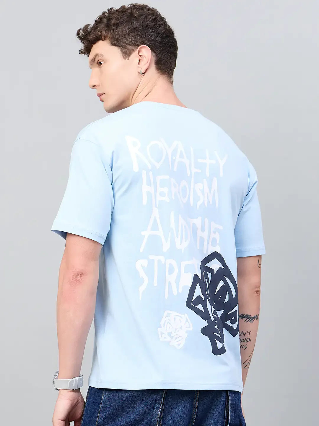 Man models the 98degreenorth Men Typography Printed Sky Round Neck T-shirt, showing its bold back graphic.