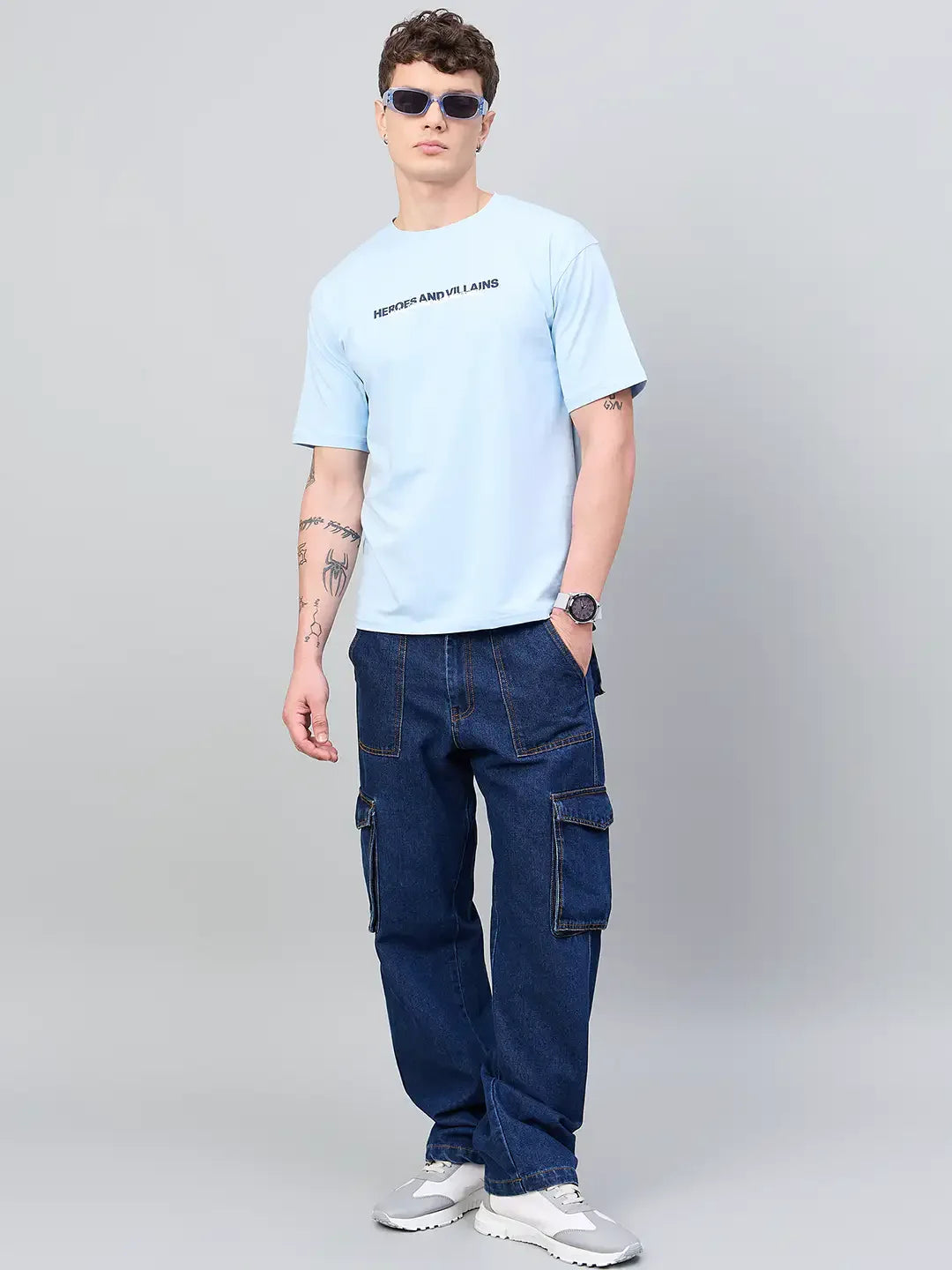 Man in 98degreenorth Men Typography Printed Sky Round Neck T-shirt poses against a plain gray background.