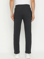 Man in 98degreenorth Men’s Anthra Fleece Trackpants with Side Stripe, shown from the back on a white background.