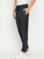 Man in 98degreenorth Men’s Anthra Fleece Trackpants with Side Stripe and white sneakers—ideal winter athleisure look.