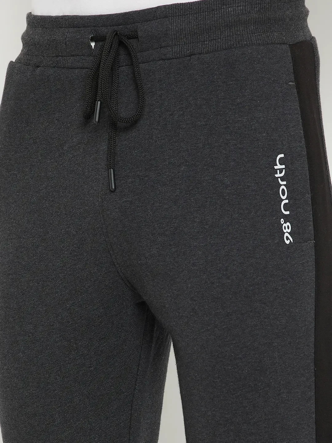 Close-up of Men’s Anthra Fleece Trackpants with Side Stripe by 98degreenorth—warm joggers with a black drawstring.