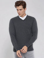 Young man in a 98degreenorth Men’s Anthra Merino Wool V-Neck Sweater, ideal for office or travel this winter.