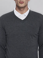 A man in a 98degreenorth Men’s Anthra Merino Wool V-Neck Sweater—an executive pullover, ideal for office winters.
