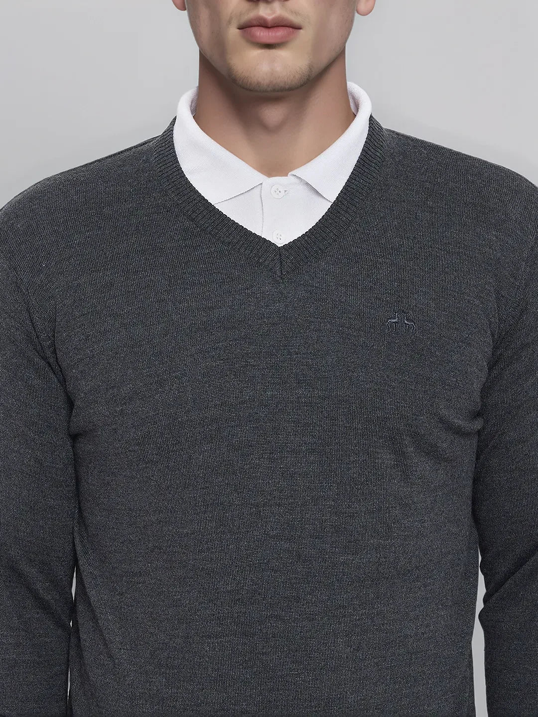 A man in a 98degreenorth Men’s Anthra Merino Wool V-Neck Sweater—an executive pullover, ideal for office winters.