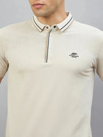 Man in 98degreenorth Men's Beige Polo T-Shirt — Handmade Series with contrast tipping and logo.