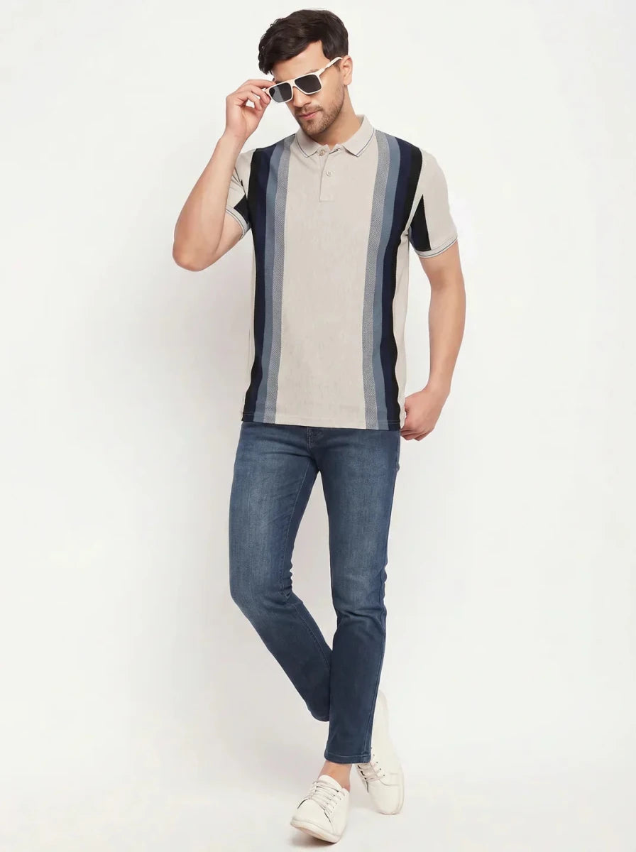 Man in 98degreenorth Beige Vertical Striped Polo T-Shirt, blue jeans & white sneakers posing against a white background.