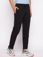 A person in 98degreenorth Men’s Black Fleece Trackpants – Warm Winter Joggers stands against a plain white background.