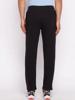A man wearing 98degreenorth Men’s Black Fleece Trackpants with ribbed waistband, shown from the back on white.