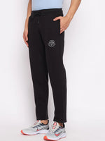 A man in 98degreenorth Men’s Black Fleece Trackpants – Warm Winter Joggers with ribbed waistband, against a plain background.