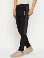 Person in 98degreenorth Men’s Black Fleece Trackpants with Side Design, paired with beige sneakers.