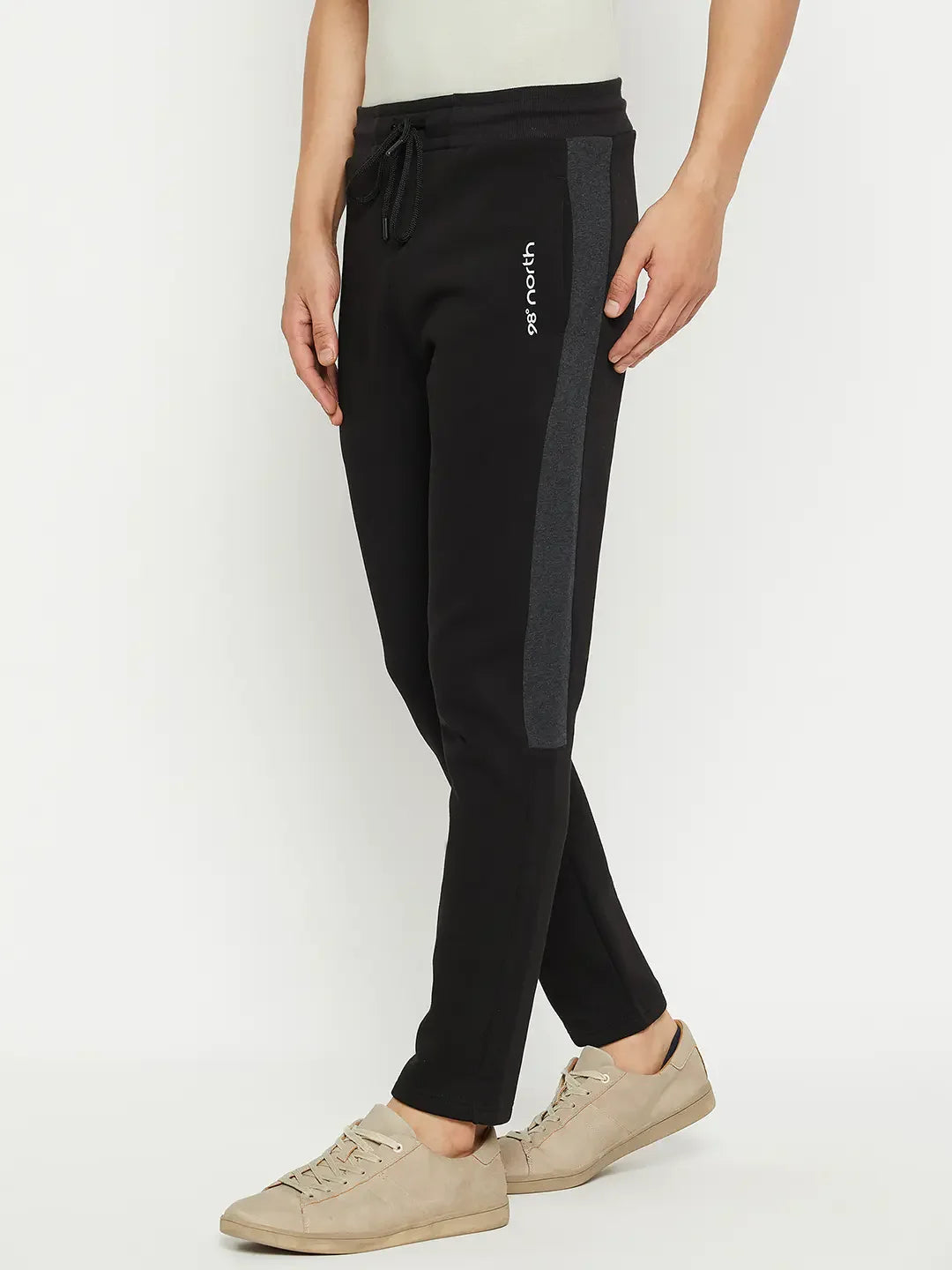 Person in 98degreenorth Men’s Black Fleece Trackpants with Side Design, paired with beige sneakers.