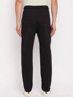 A person wears 98degreenorth Men's Black French Terry Lycra Trackpants, facing away against a white background.