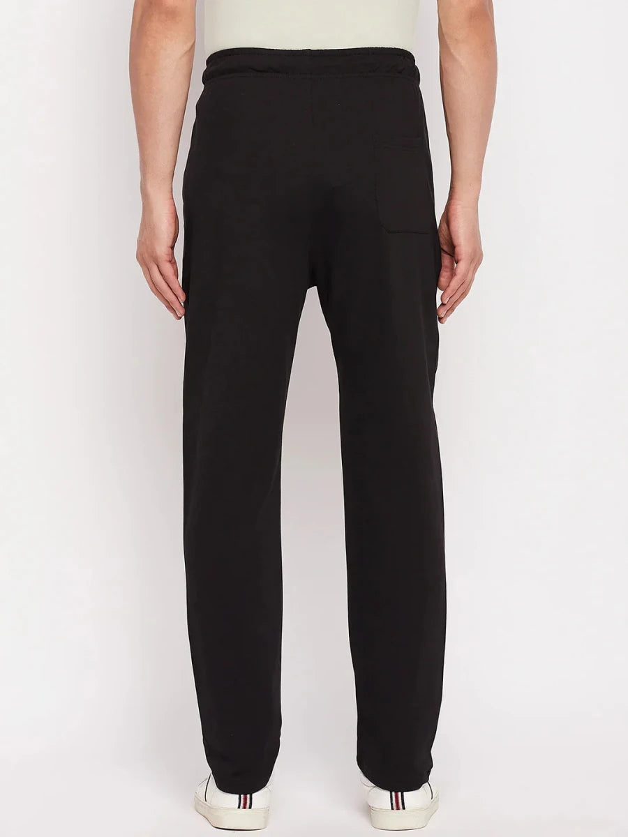 A person wears 98degreenorth Men's Black French Terry Lycra Trackpants, facing away against a white background.