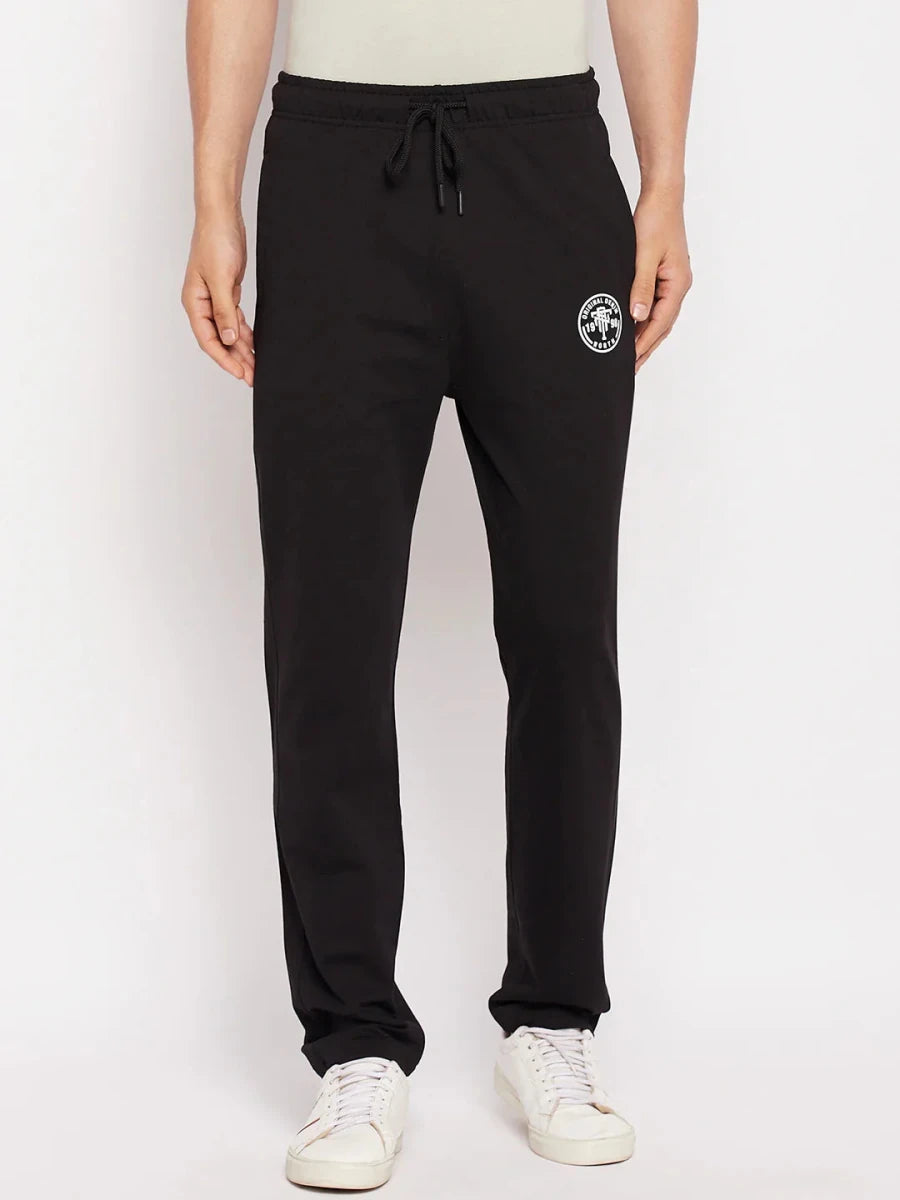 Man in 98degreenorth Men's Black French Terry Lycra Trackpants, white sneakers, and a light shirt.