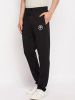 Man in 98degreenorth Men's Black French Terry Lycra Trackpants, white sneakers, and a light shirt.