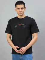 Man in 98degreenorth Men's Black Graphic Oversized T-Shirt—Burn It Down print, standing against a plain background.