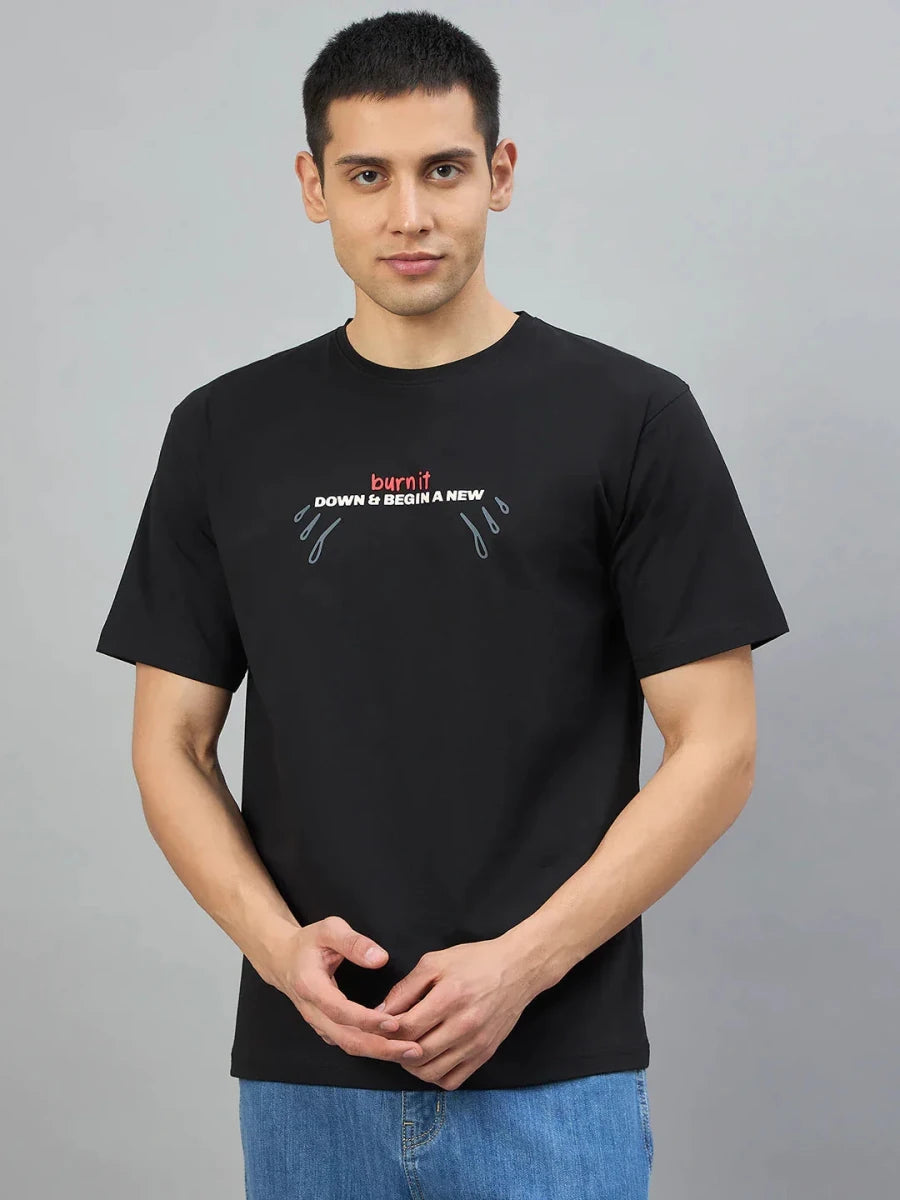 Man in 98degreenorth Men's Black Graphic Oversized T-Shirt—Burn It Down print, standing against a plain background.
