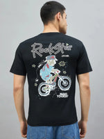 Man in 98degreenorth's black oversized RockStar graphic tee, cartoon biker back print, facing away.